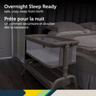 Safety 1st EasyGlide Bedside Bassinet placed next to an adult bed in a bedroom setting, safe and cozy for overnight sleep from birth.
