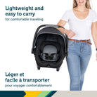 Mother easily carrying the lightweight Safety 1st onBoard FLX infant car seat by the ergonomic handle.