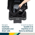 Detail of a hand easily detaching the machine-washable and dryer-safe car seat pad for simple cleanup.